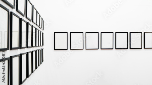 Roll of picture frames hanging on white wall