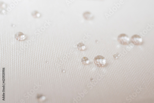 Clear water drops on white canvas