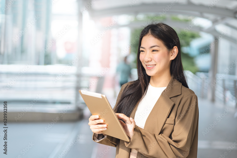 Business asian woman using digital tablet for internet browsing in the city Business asian woman using digital tablet for internet browsing in the city
