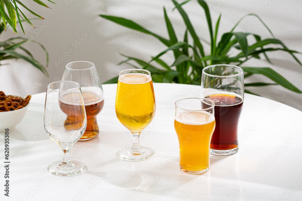 glasses with cold beer snack food and drink on light table