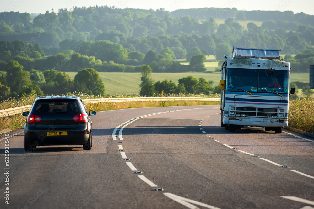 caravan moving at speed on uk motorway in england at sunrise