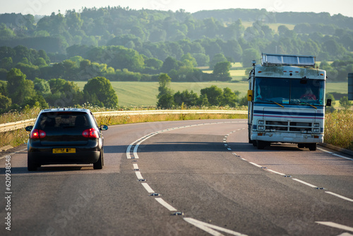 caravan moving at speed on uk motorway in england at sunrise photo