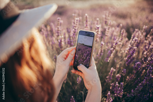 person with mobile phone in lavander field photo