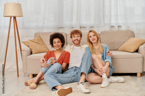 polygamy, acceptance and bonding, group relationship, love triangle, happy multicultural women and bearded man, open relationship, diversity and bonding, non monogamy, three people looking at camera