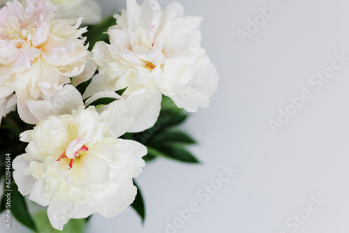 Close up of beautiful fragile white peonies bouquet
