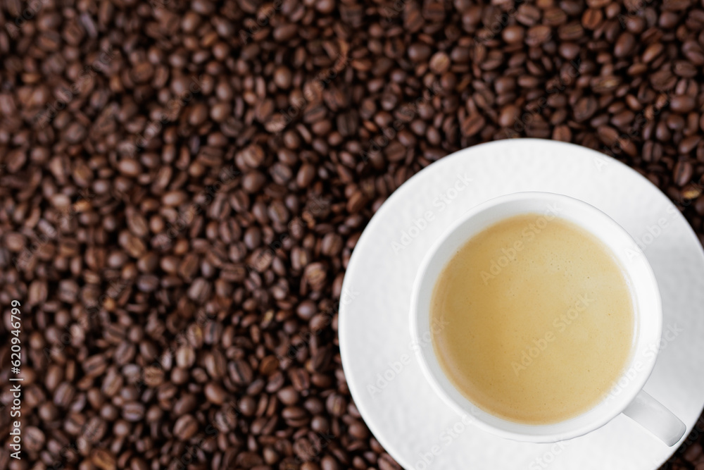 Top view of espresso with coffee foam in a cup on a dark background from coffee beans with copyspace Top view of espresso with coffee foam in a cup on a dark background from coffee beans with copyspace