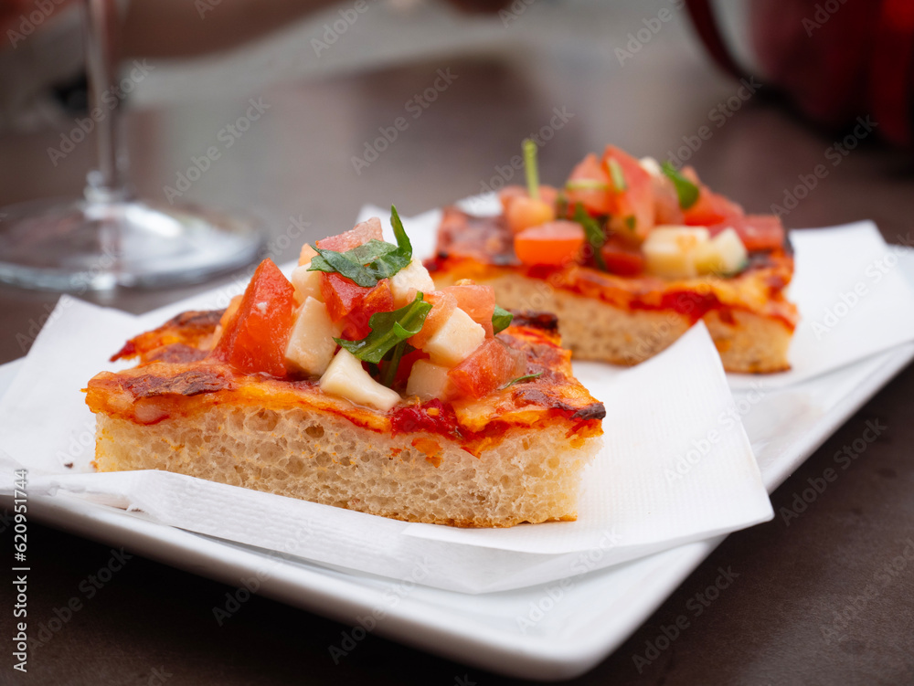 Slices of pizza for Italian aperitif at the bar Italian appetizer on the table. Slices of pizza for Italian aperitif at the bar Italian appetizer on the table.