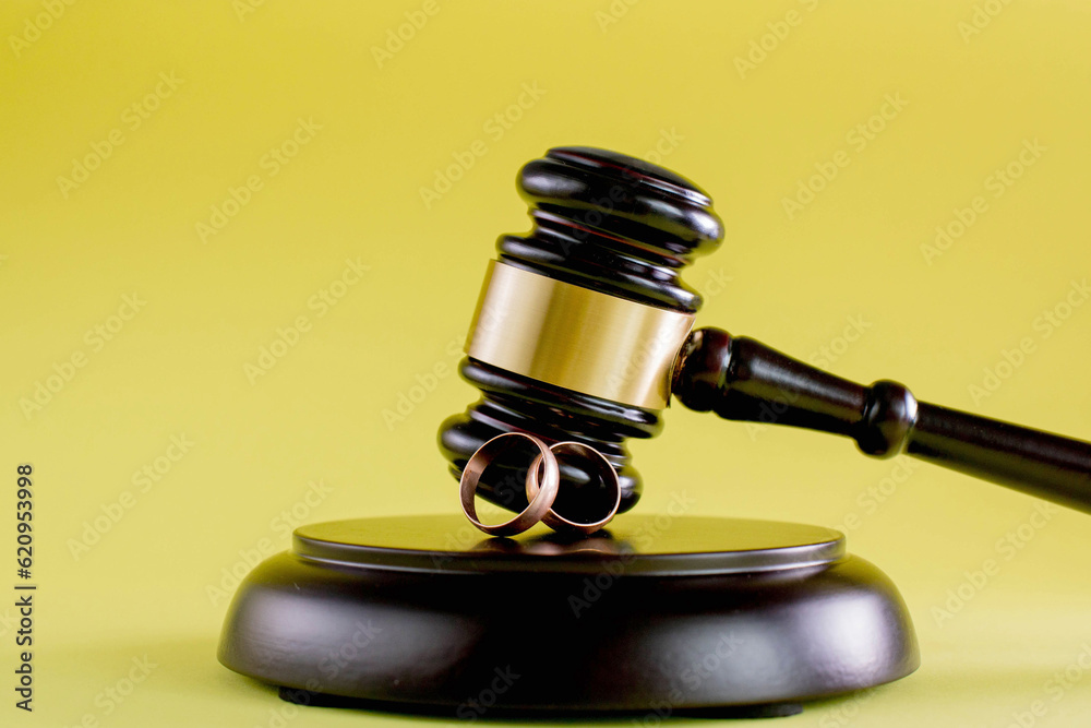 Judge gavel and two golden marriage ring, Contract decree of divorce dissolution or cancellation of marriage Judge gavel and two golden marriage ring, Contract decree of divorce dissolution or cancellation of marriage