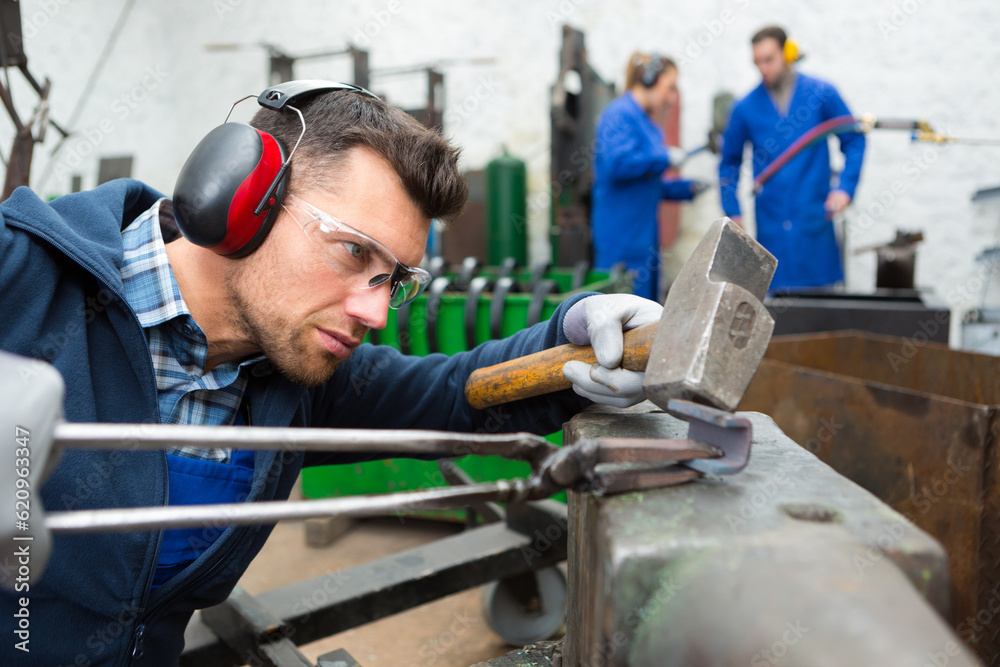 portrait of man forging with hammer portrait of man forging with hammer
