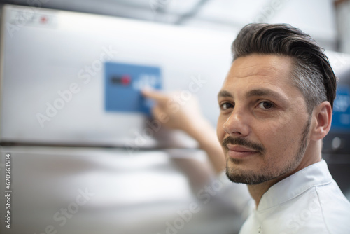 young factory technician psoing at workplace