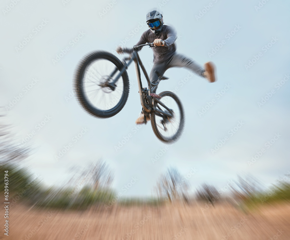 Mountain, bicycle jump and athlete cycling on a bike for extreme sports competition stunt or training in nature. Skill, contest and person workout or action on sky or air trick for fitness with blur Mountain, bicycle jump and athlete cycling on a bike for extreme sports competition stunt or training in nature. Skill, contest and person workout or action on sky or air trick for fitness with blur