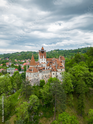Medieval Bran Castle, aerial drone perspective. Known as Dracula's Castle, it is visited annually by many foreign tourists. One of the best-known tourist attractions of Romania. Vertical photography.