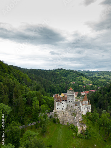 Medieval Bran Castle  aerial drone perspective. Known as Dracula s Castle  it is visited annually by many foreign tourists. One of the best-known tourist attractions of Romania. Vertical photography.
