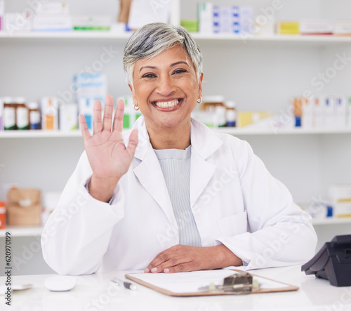 Pharmacist, portrait and hand of woman for hello at pharmacy counter for friendly service with a smile. Mature female employee in healthcare, pharmaceutical and medical industry for medicine retail