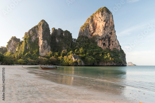 longboat on the beach with limestone cliffs in the background, Railay beach, Krabi, Thailand