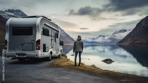 Foto Woman with RV Camper looking at lake and mountains during Holiday