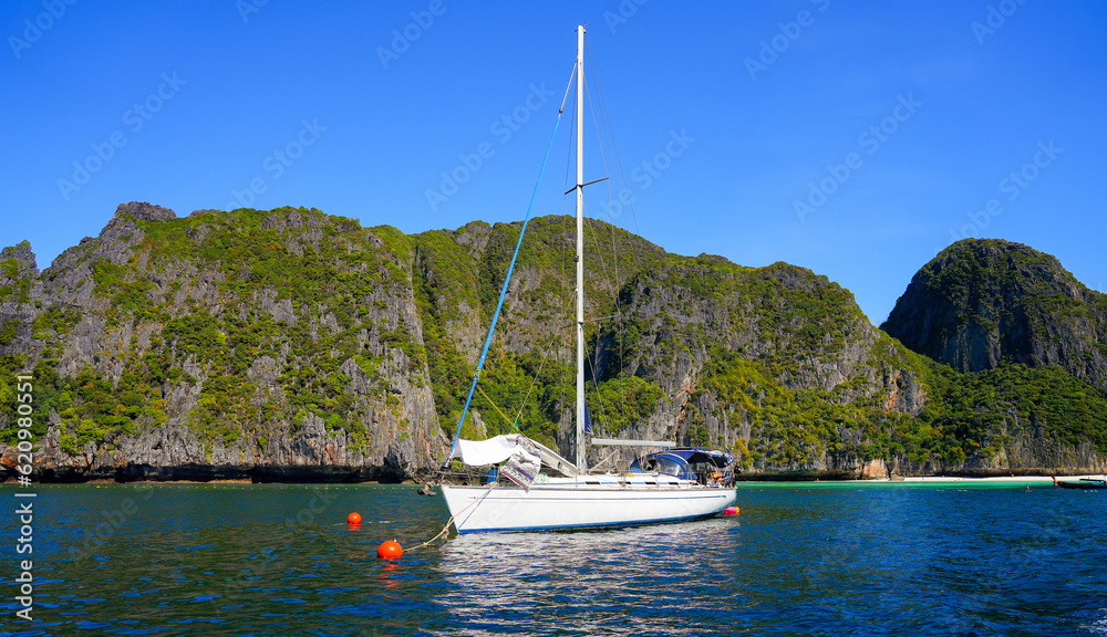 Fototapeta premium Sailboat in the shallow waters of Maya Bay on Koh Phi Phi Ley island in the Andaman Sea, Krabi Province, Thailand