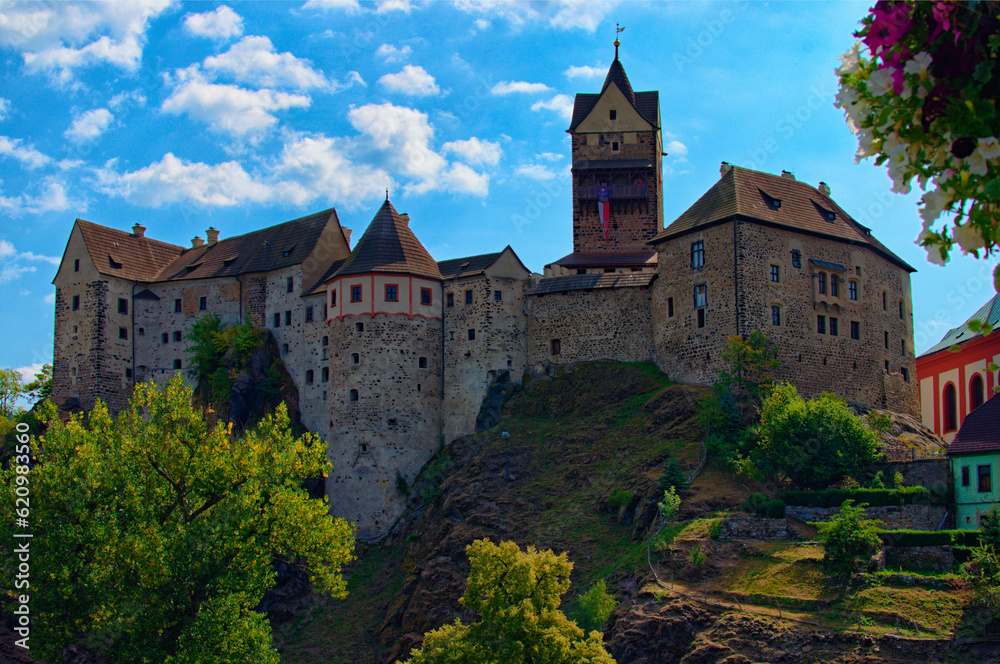 Landscape view of medieval Loket castle in Czech Republic. Famous touristic place and romantic travel destination. Romantic castle with colorful houses. UNESCO World Heritage Site