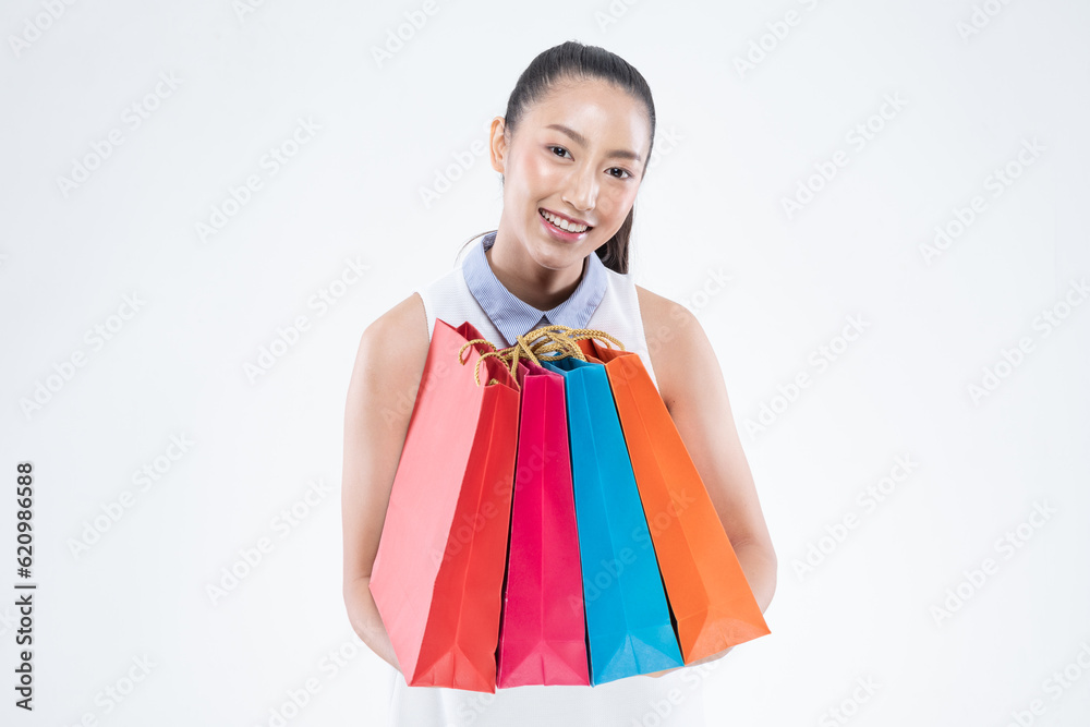 Beautiful Attractive Asian Woman smile and holding shopping bags feeling so happiness and enjoy with black Friday sale in Shopping mall,isolated on white background. Shopping Lifestyle Concept Beautiful Attractive Asian Woman smile and holding shopping bags feeling so happiness and enjoy with black Friday sale in Shopping mall,isolated on white background. Shopping Lifestyle Concept
