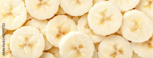 Background of ripe sliced yellow healthy banana slices, closeup. Food organic natural backdrop from fruit