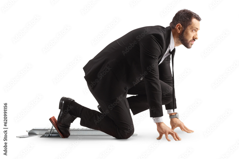 Full length profile shot of a businessman preparing for a run on starting blocks Full length profile shot of a businessman preparing for a run on starting blocks