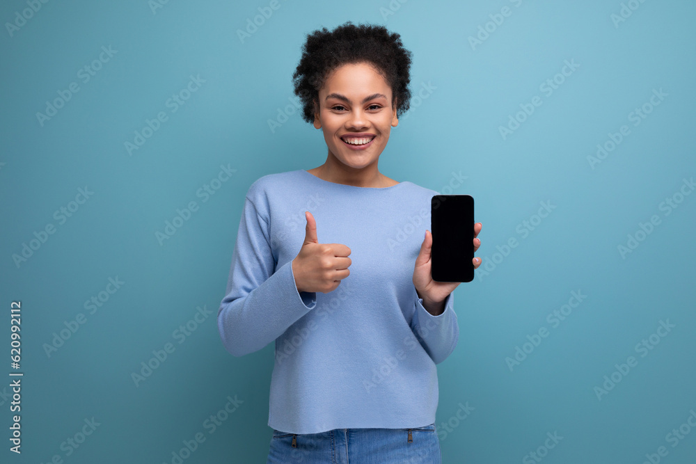 positive young latin 20s woman with black hair pays for purchases using the application in the phone positive young latin 20s woman with black hair pays for purchases using the application in the phone