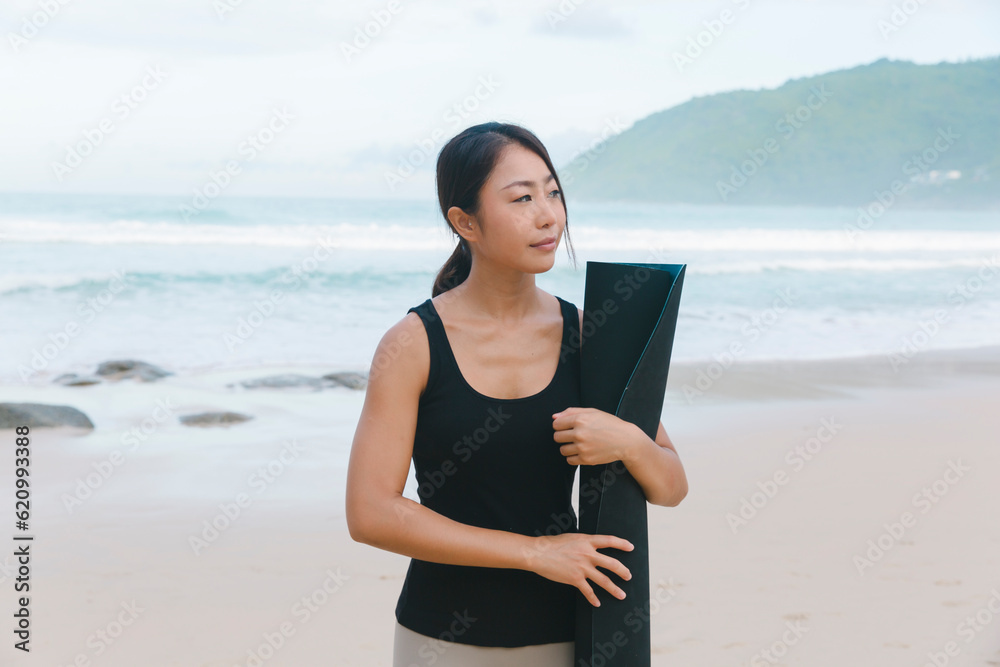 Young woman looking for a place for yoga on a secluded beach
