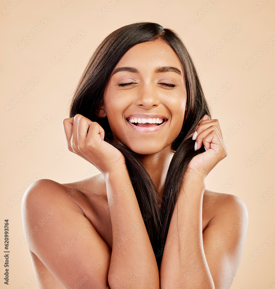 Fototapeta premium Beauty, hair care and face of a happy woman in studio with natural glow and shine. Hairstyle, cosmetics and wellness of a Indian person for hairdresser, makeup or salon results on a beige background
