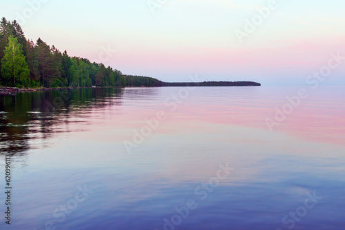 Fototapeta Naklejka Na Ścianę i Meble -  Evening summer landscape of the water surface after sunset.