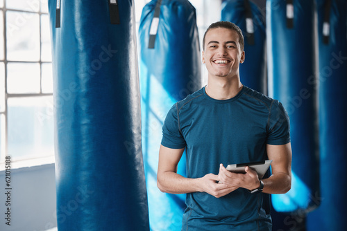 Fitness, man and gym coach with tablet ready for exercise class and training with a smile. Young male person, athlete and wellness center for personal trainer happy from workout with digital app