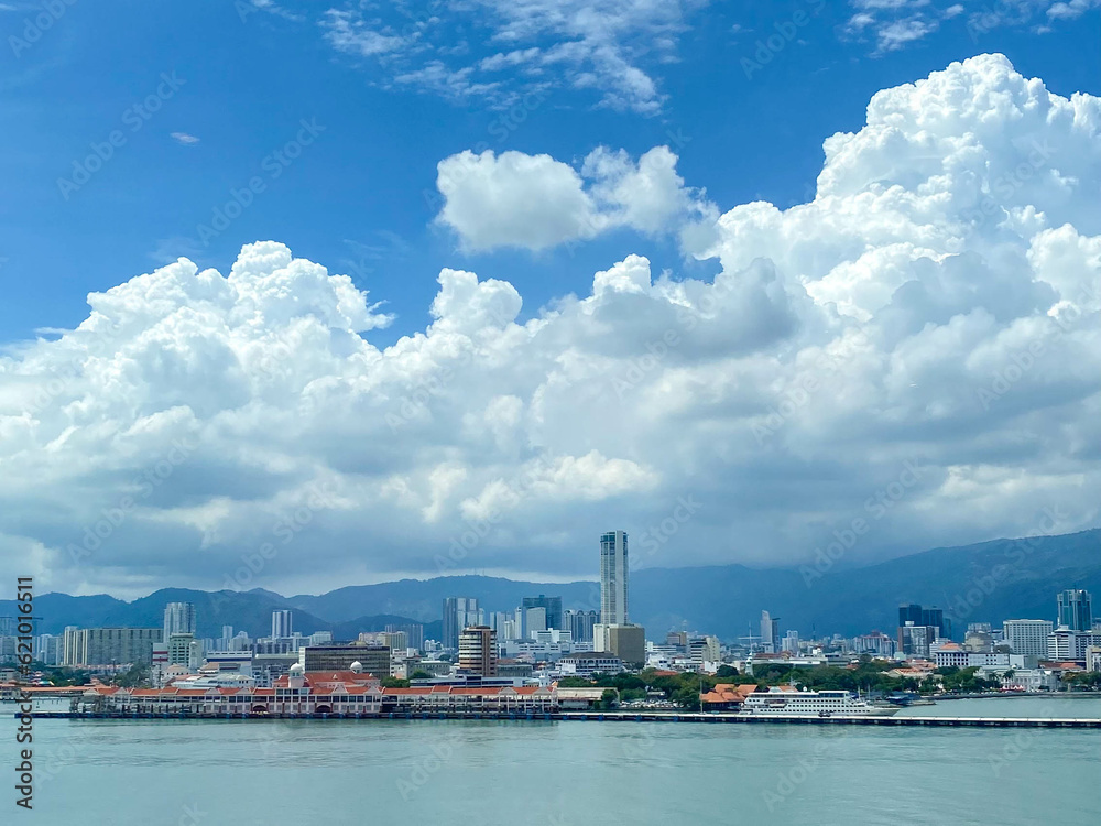 View of Penang city from sea with clear blue sky and white clouds, famous town in Malaysia