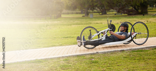 Cycling, fitness and space with man and handcycle in nature for training, sports contest and challenge. Exercise, workout and banner with person with a disability in park for cardio and health mockup photo