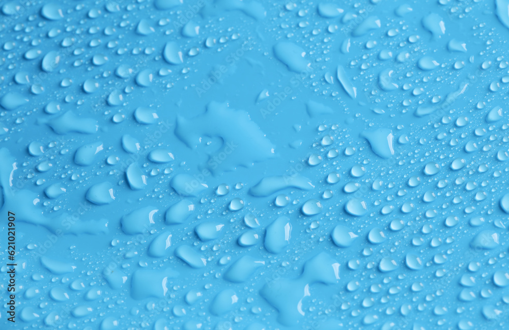 Blue background in water drops close up