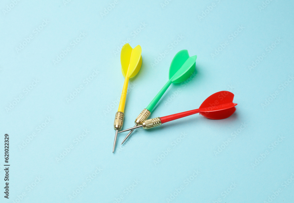 Yellow, green and red darts on blue background. Yellow, green and red darts on blue background.