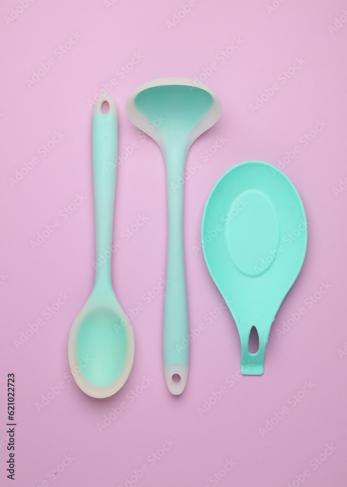 Silicone kitchen utensils on a pastel background. Top view Silicone kitchen utensils on a pastel background. Top view