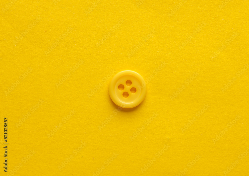Plastic yellow buttons on a yellow background