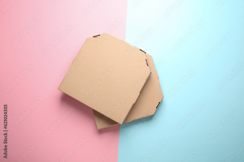 Two craft cardboard pizza boxes on pink blue background. Template for design. Top view