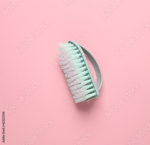 Blue Plastic brush for cleaning on pink background