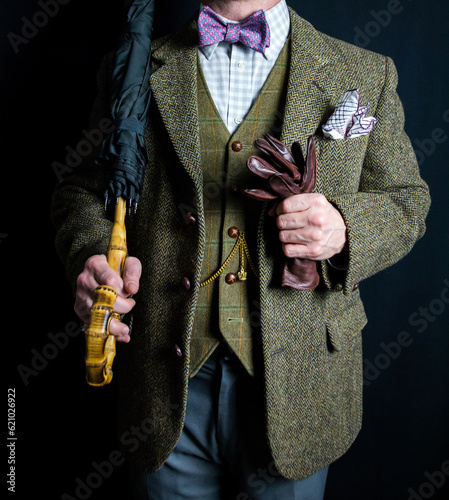 Portrait of Businessman in Tweed Suit Holding Umbrella and Leather Gloves. Vintage Style and Retro Fashion of Elegant English Gentleman.