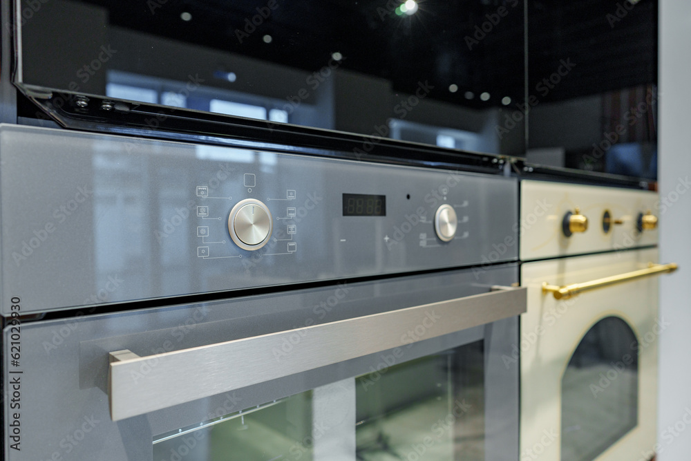 New ovens in household appliance section in store New ovens in household appliance section in store
