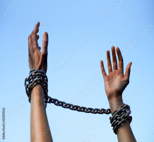 Praying man with shackled hands