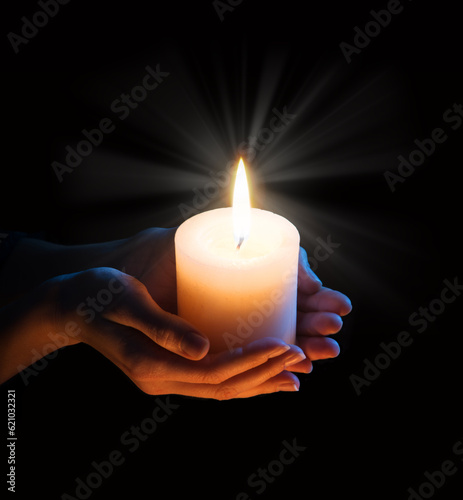 Women s hands holding a candle