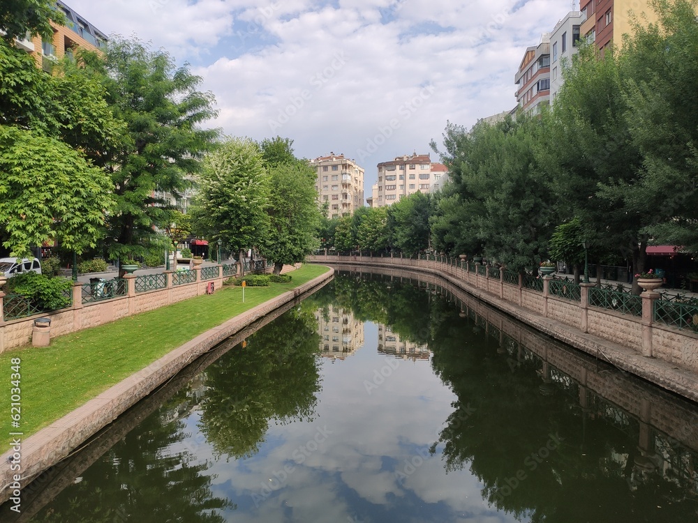 view of a small river and trees from a bridge in a park in the city of Eskişehir