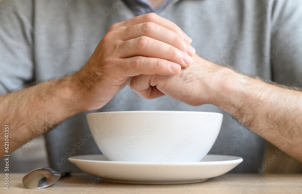 Waiting for food: empty plate and man's hands Waiting for food: empty plate and man's hands