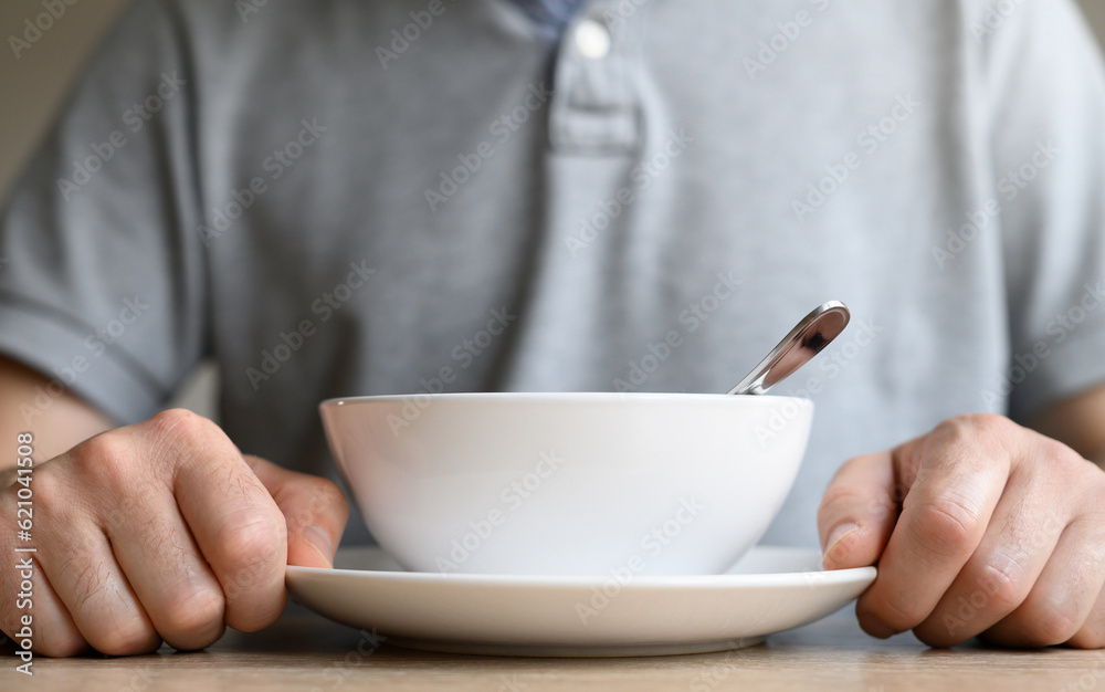 Awaiting Culinary Delight: white soup plate and man's hands Awaiting Culinary Delight: white soup plate and man's hands