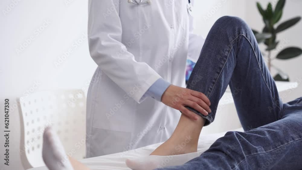 Doctor and patient are at the usual medical inspection in the clinic. Therapist examines a young woman's knee. Medicine concept Doctor and patient are at the usual medical inspection in the clinic. Therapist examines a young woman's knee. Medicine concept