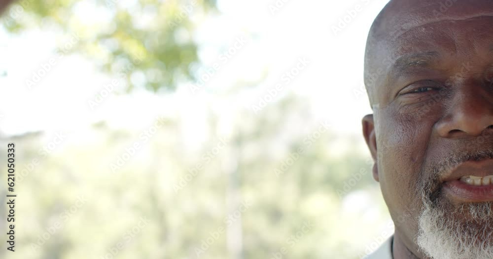 Half portrait of happy senior african american man on sunny terrace with copy space, slow motion Half portrait of happy senior african american man on sunny terrace with copy space, slow motion
