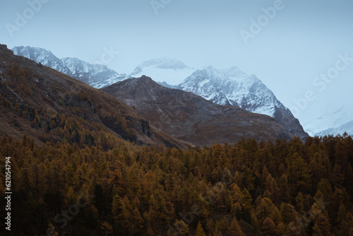 Blue Hour shot of the snow peaks of Mount Corvatsch, during a cloudy autumnal day, Swtizerland