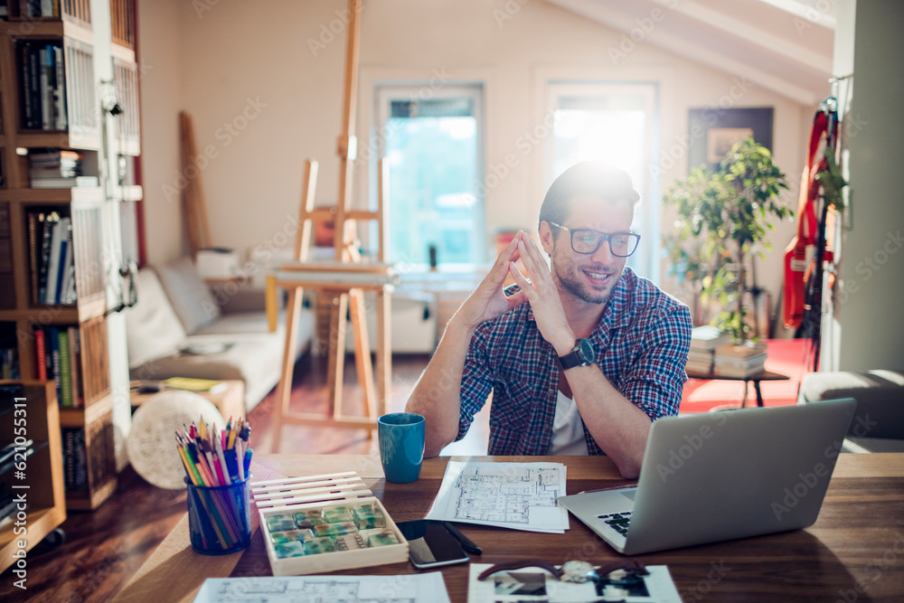 Young man working from home on his laptop Young man working from home on his laptop