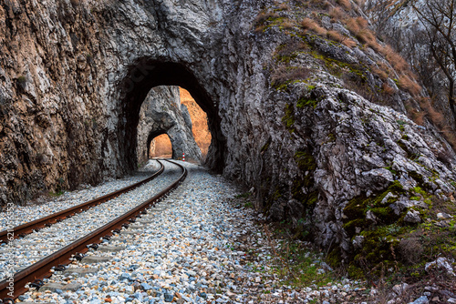 Old railway passing through short tunnels in picturesque rural scenery